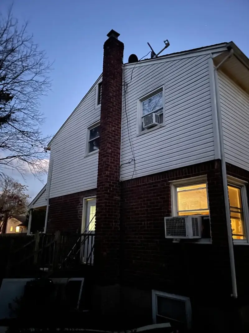 Back of a two-story house with a brick lower level, Centereach, NY