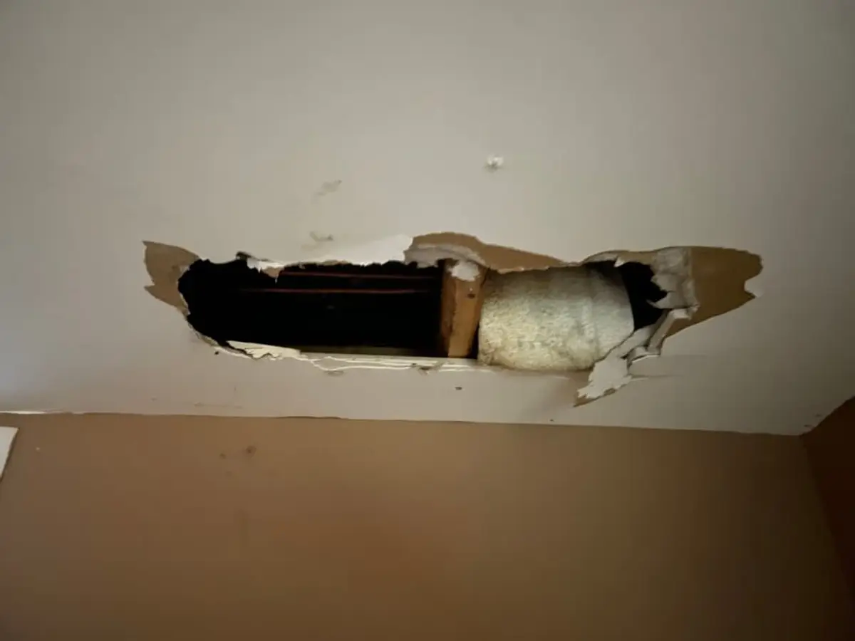 Selling a multi-family house in Centereach: hole broken through a wall above a doorway