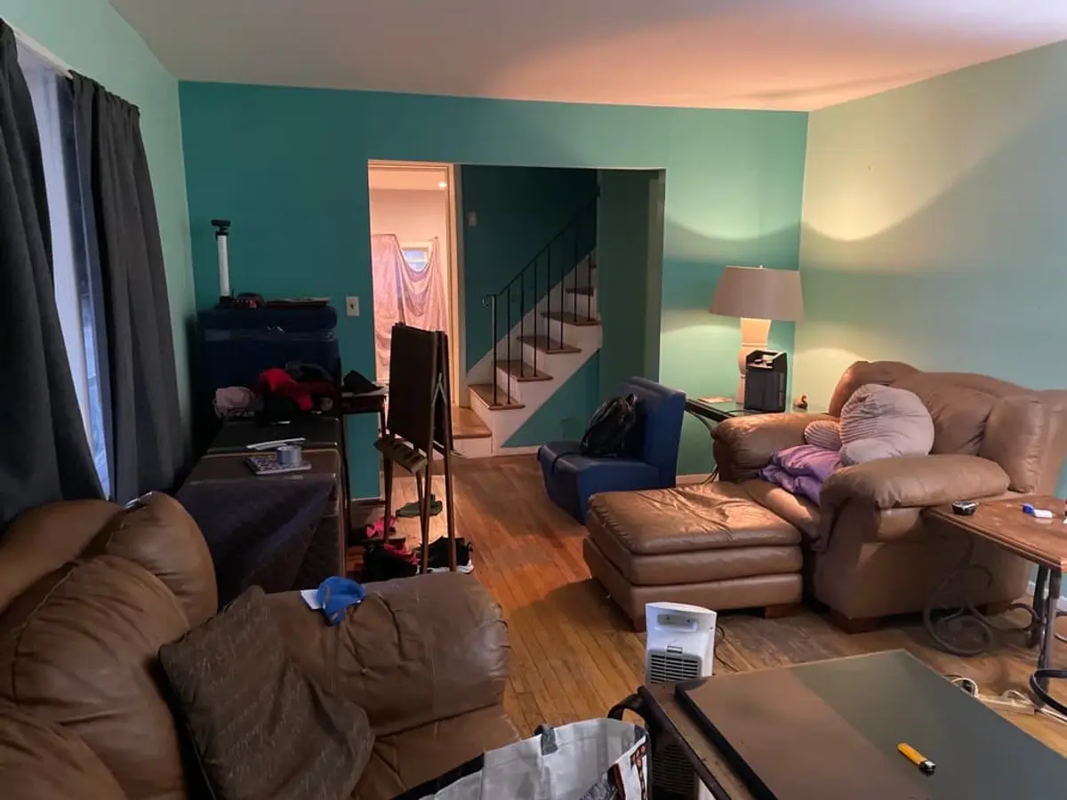 Downsizing or retiring in Centereach: living room with leather sofas and teal walls